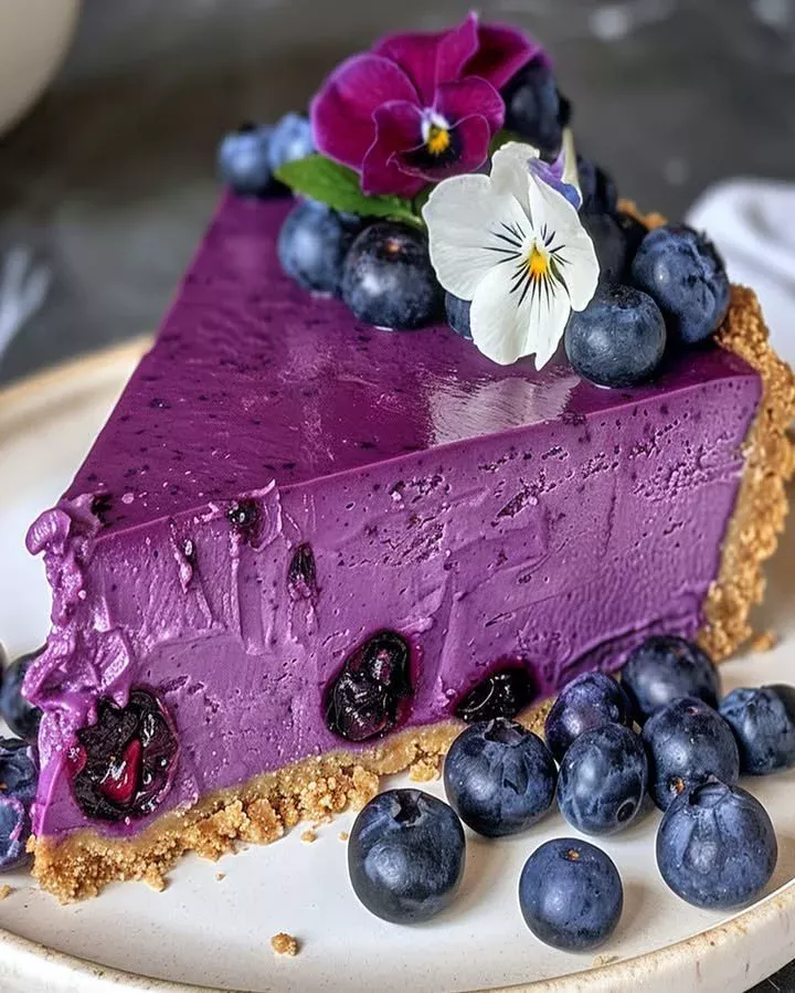 Blueberry cheesecake topped with lavender flowers for an elegant dessert presentation