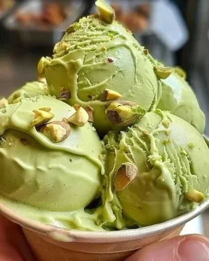 Delicious creamy pistachio gelato in a dessert bowl with pistachio pieces