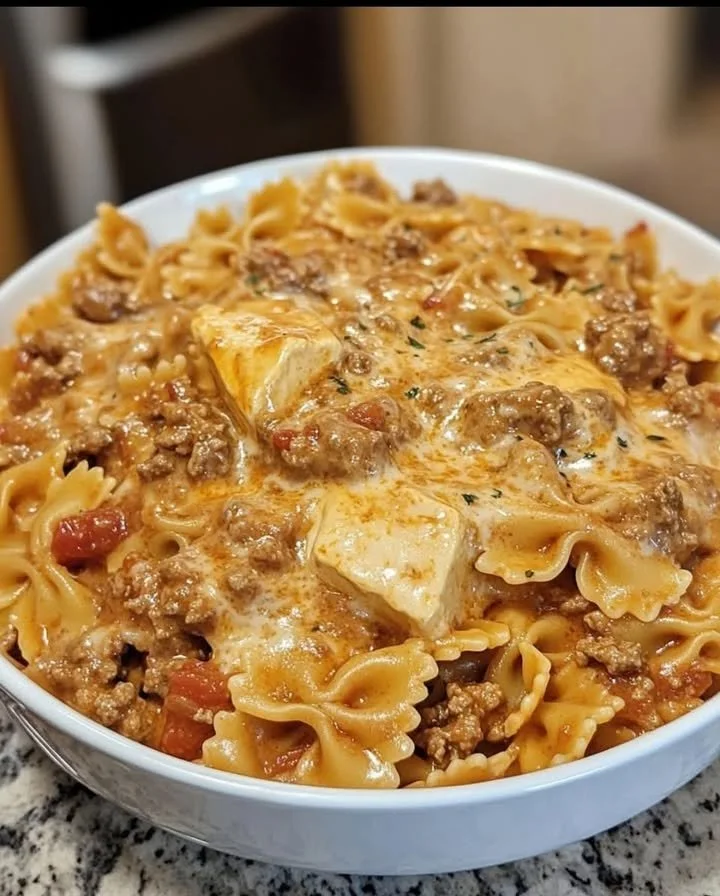 Creamy Velveeta beef bowtie pasta served in a bowl with herbs