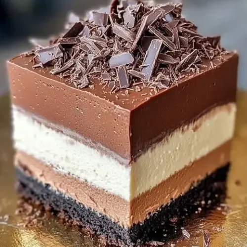 Triple chocolate mousse cake with layers of creamy chocolate delight